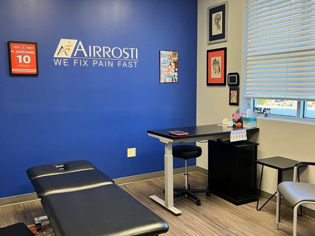 a photo of the treatment room at Airrosti Allen. The treatment table is showcased in the middle of the room.